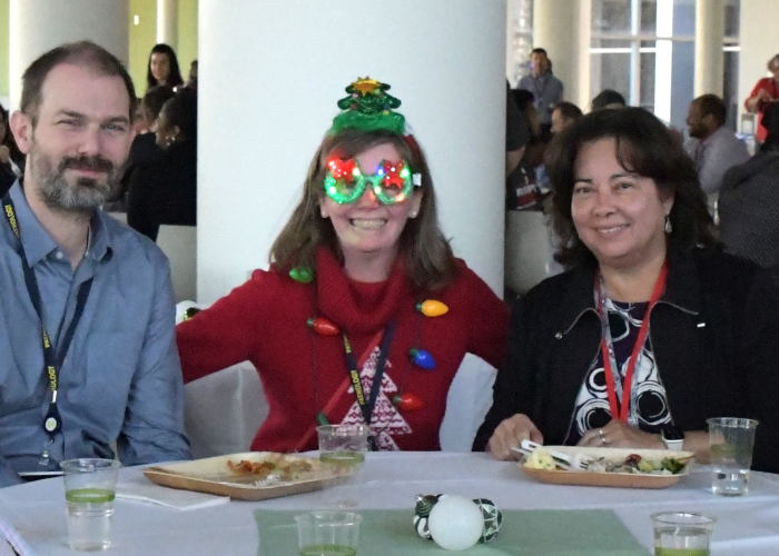 Regina with friends, Dr. David Manthei and Marie Goldner at the Department's 2023 holiday party.png